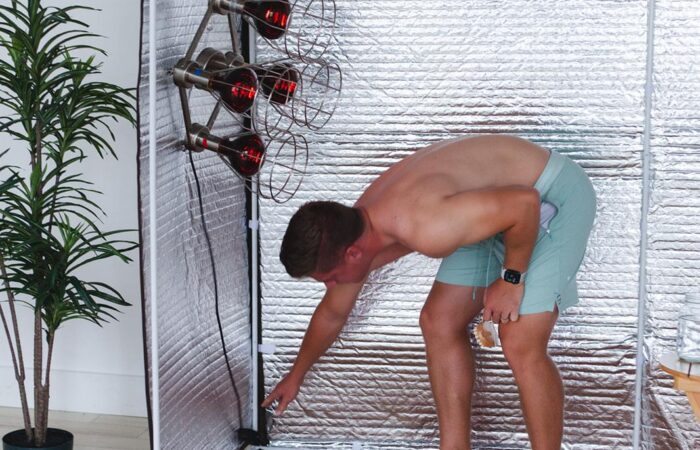 Sweat session forward fold beside the near infrared lamps