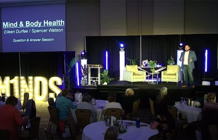 Eileen Durfee speaking on stage about mind and body health
