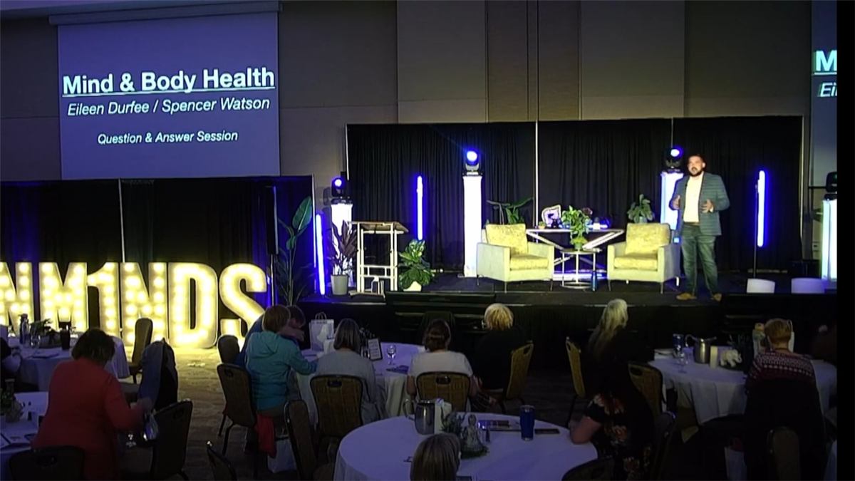 Eileen Durfee speaking on stage about mind and body health