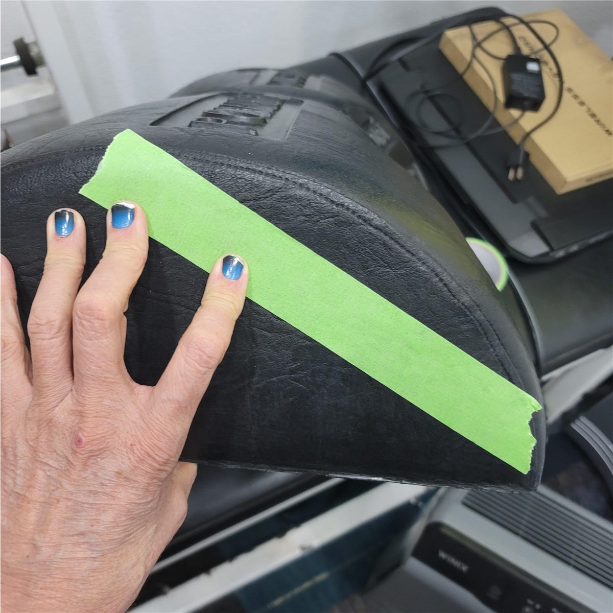 Hand-shaped foam roller prototype with masking tape during development