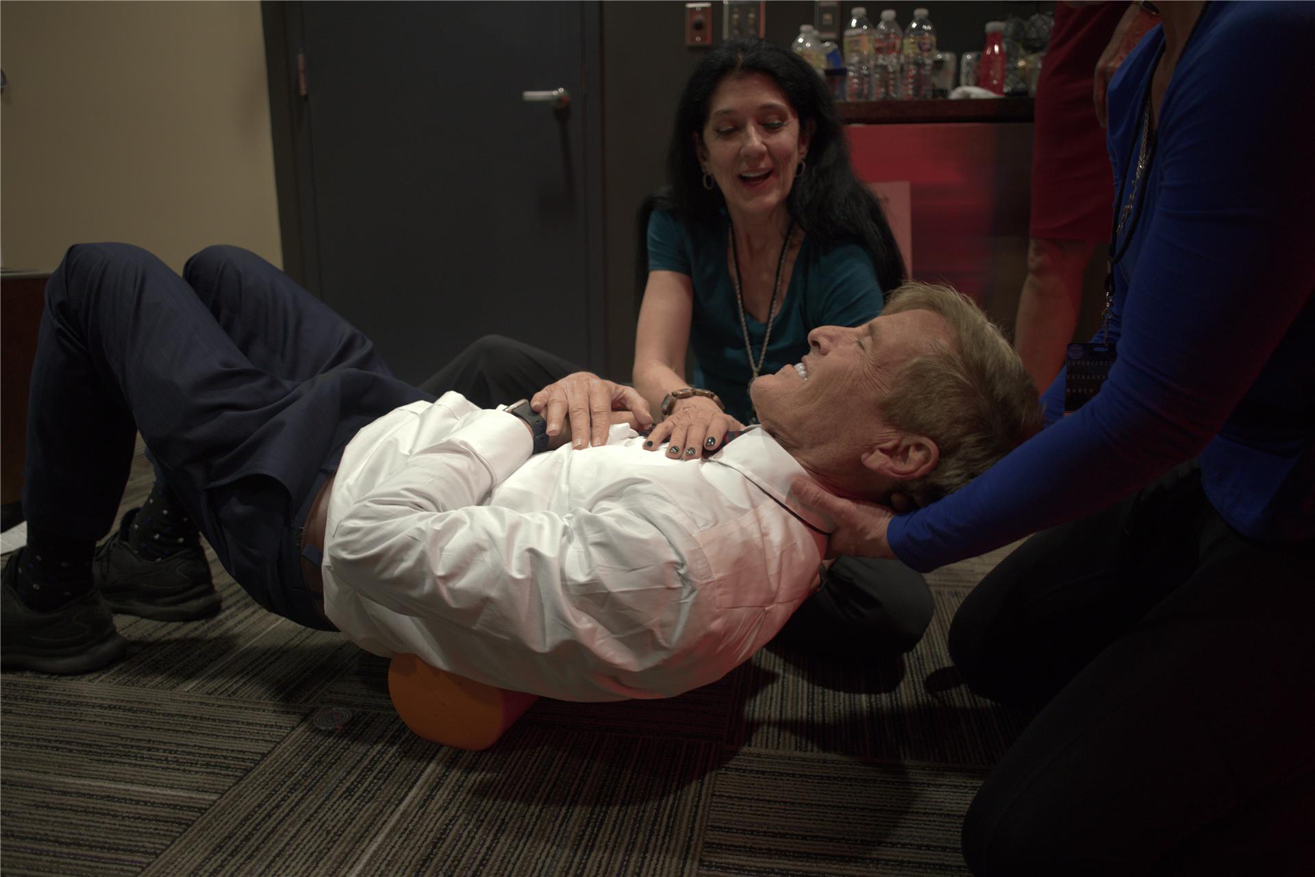 Smiling man doing spinal fitness exercises for healthy aging