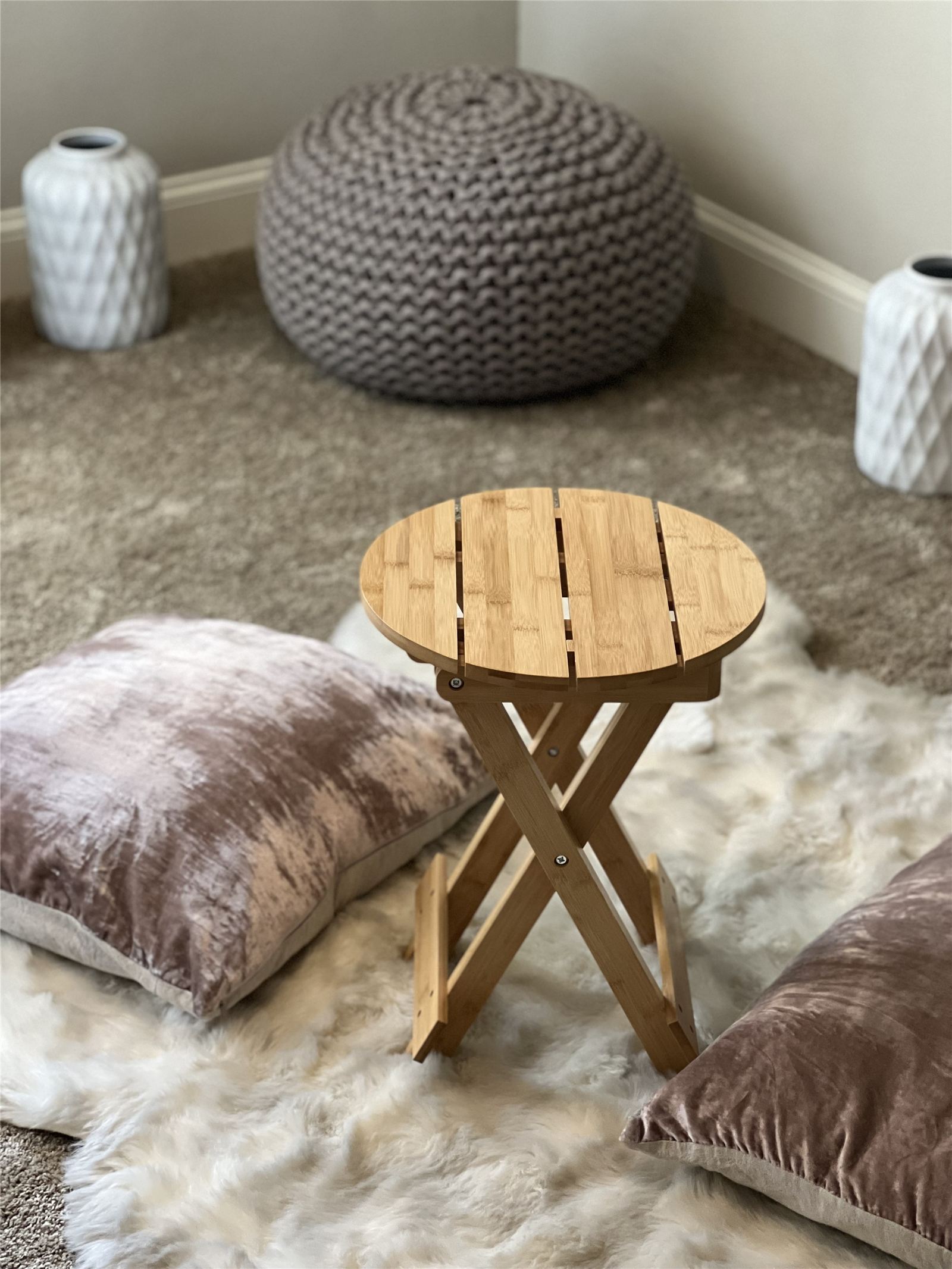 A home recovery corner with bamboo folding stool and organic fleece rug