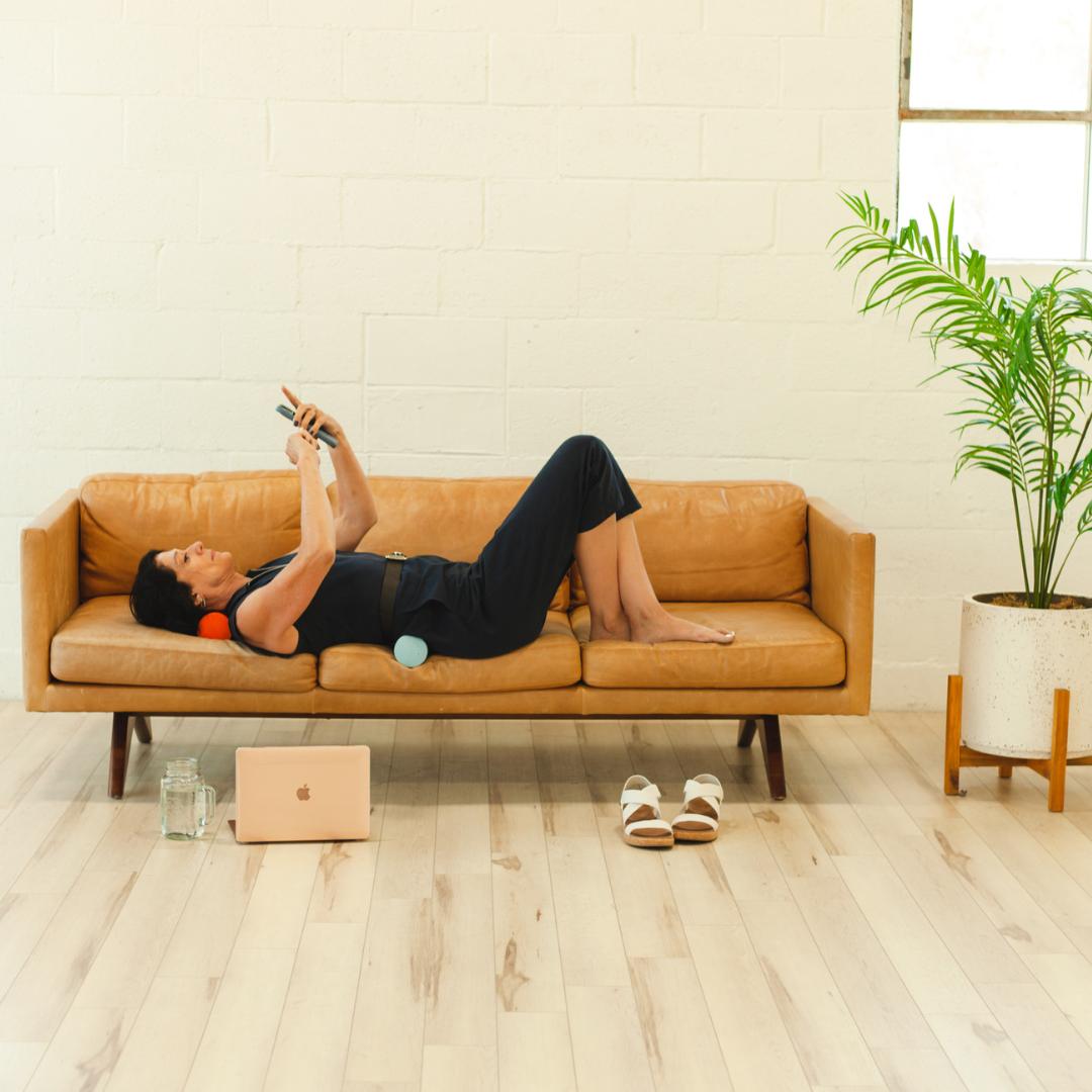 Relaxed home recovery with a foam roller on the couch